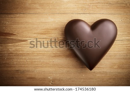 Chocolate heart on wooden background  - stock photo