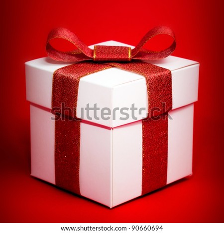 White box with a red ribbon on red background