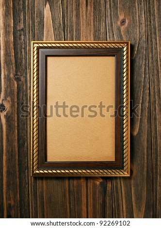 ancient style golden photo image frame on wood background