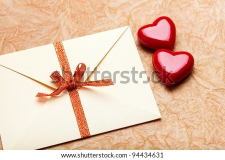 Envelope with valentine card on paper background