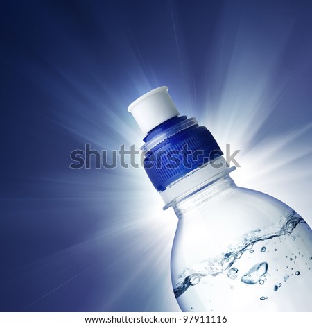 Small bottle of water on blue background with ligth