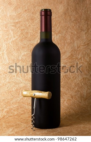 wine bottle and corkscrew on a paper background