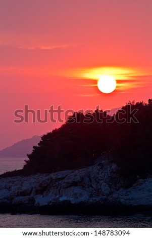 Beautiful Sea Sunset. Red Sun, Mountain, Deep Sea.