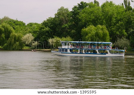 Blue and white lake boat on Herastrau Lake in Bucharest - Romania