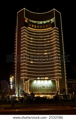 Modern high building in the night in Bucharest - Romania