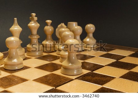 White wooden chess pieces perspective