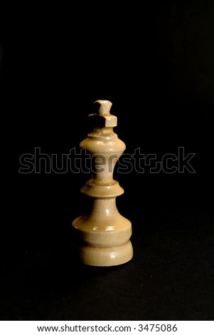 White chess king piece in shadow