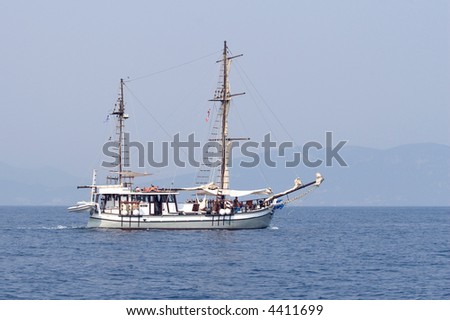 People sailing with an old style boat