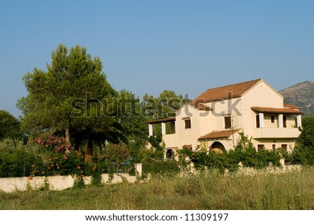 Typical greek architecture house with green garden