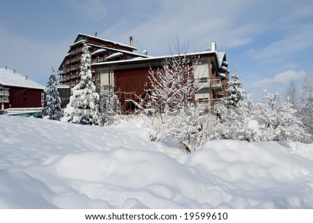 Winter paradise with fresh snow and wood cottage