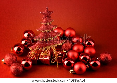 Christmas postcard over red background with sparkle red christmas tree, red globes and shinny red gifts with golden ribbons