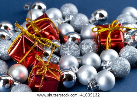 Red gift boxes over silver christmas globes
