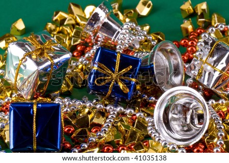 Sparkly christmas background with blue and silver gift boxes, golden stones and silver bells