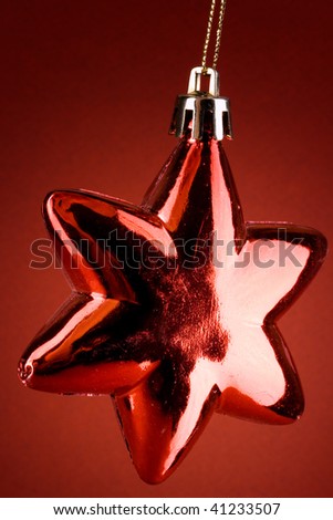 Hanging single red star globe over red background