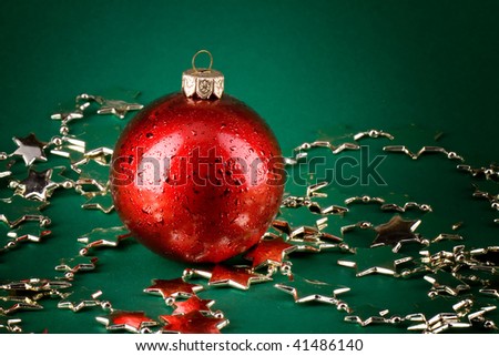 Shinny christmas red globe over green background and silver stars