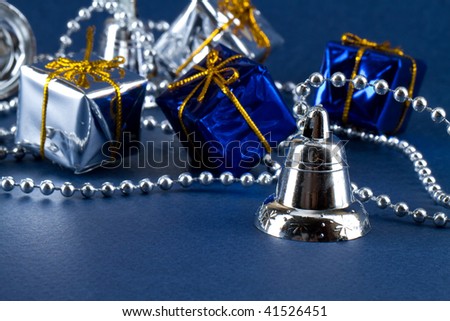 Christmas silver bell with pearls and christmas shinny gift boxes with golden ribbon