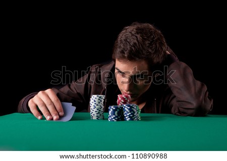 Young handsome man playing texas hold\'em poker