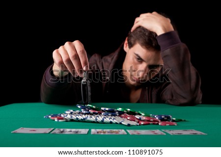 Young desperate man gambling his car in texas hold\'em poker game