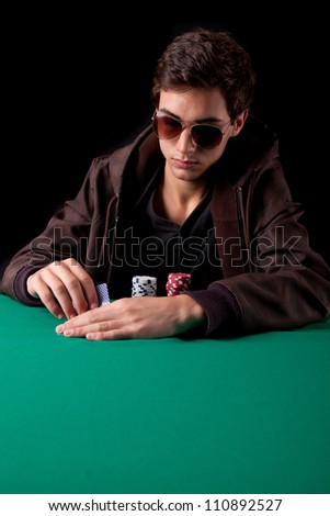 Young handsome man playing texas hold'em poker
