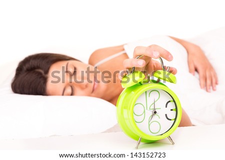 Woman waking up with the sound of the alarm clock