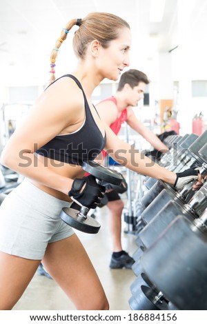 A young and beautiful woman working out at the gym