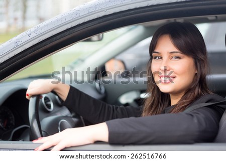 Business woman driving her new sports car