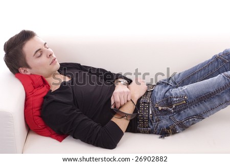 Young boy sleeping on couch, isolated over white