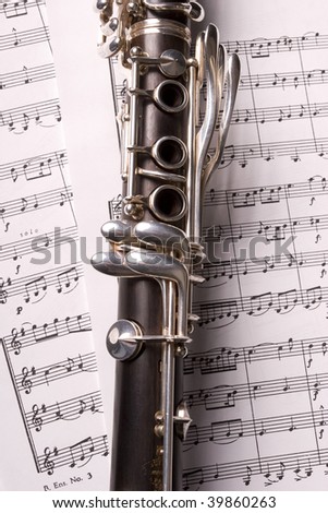 Photograph of a clarinet isolated over sheet music