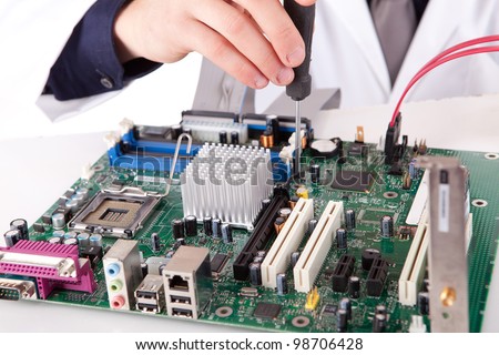 Computer engineer working on an old motherboard - selective focus