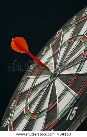 darts board with one dart stuck in the middle