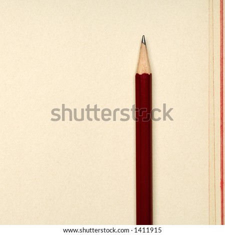 sharp red pencil on yellow paper