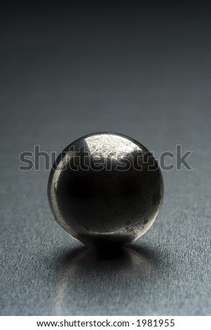 shiny metal ball on reflective surface