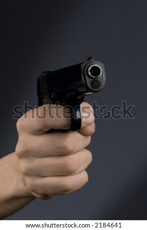 hand holding black revolver