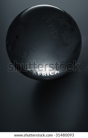 a glass globe glowing in dark - word Africa illuminated
