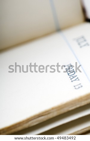 a page in a calendar book - friday the 13th - shallow depth of field