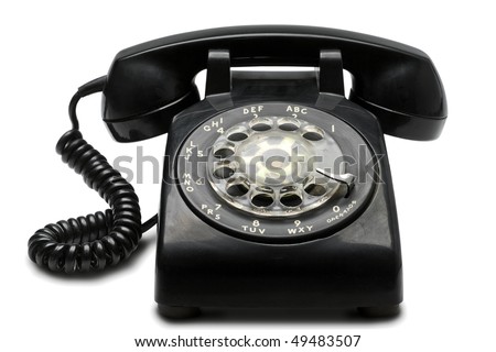an old black rotary phone on white with clipping path
