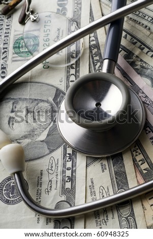 a stethoscope and a pair of rimless glasses on various US bills