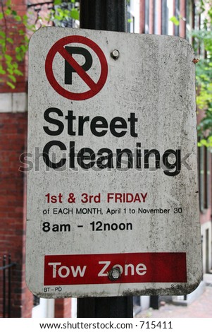 A very dirty street cleaning sign in Boston in serious need of cleaning.