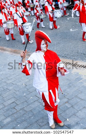 IEPER, BELGIUM - MAY 13, 2012: Smiling red and white joker waves her stick on the 43th edition of the Cat Parade in Ieper, Belgium on May 13, 2012