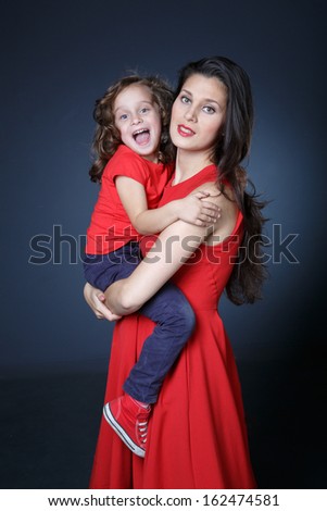 Mother holds her little girl in her arms