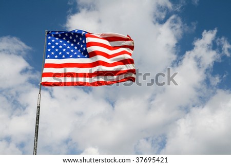 american flag flaps on the wind attached to the old pole