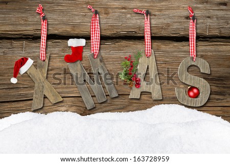 xmas letters with snow on wooden background