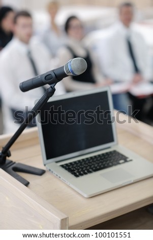 business laptop and microphotone at podium on seminar conference education
