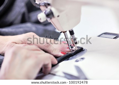 woman Hands of Seamstress Using Sewing Machine tailor and new clothes fahion reparation concept