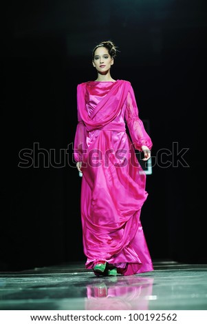 beautiful young fashion model woman walking on  show event