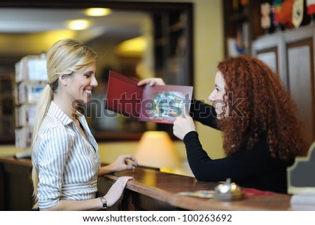 business woman  at the reception of a hotel checking in