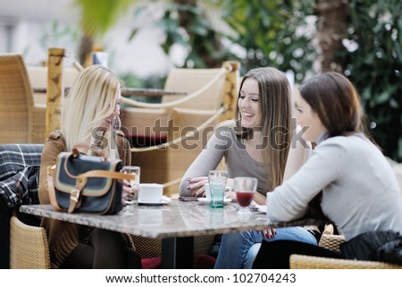 very cute smiling women drinking a coffee sitting inside in cafe restaurant very cute smiling women drinking a coffee sitting inside in cafe restaurant