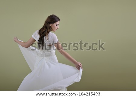 Portrait of a beautiful woman dressed as a bride isolated on white background in studio
