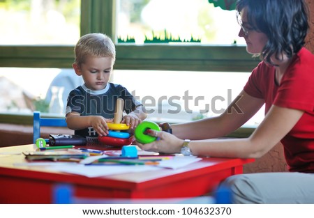 happy little child play game and have fun, education lessons in colorful kinder garden playground indoors