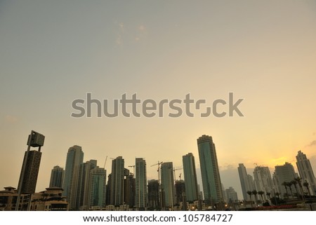 dubai city skyline at sunset conctruction and modern architecture concept